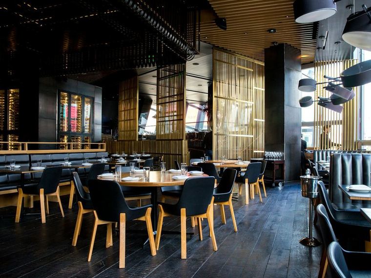 A restaurant dining room set for service